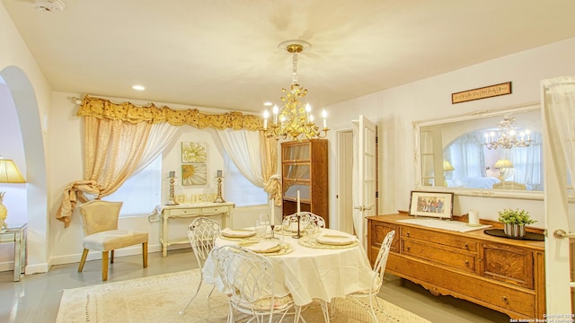 interior space with a chandelier and light hardwood / wood-style floors