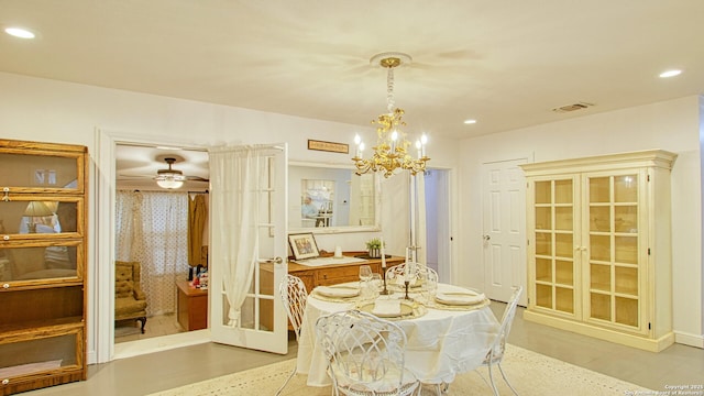 dining space featuring french doors and ceiling fan with notable chandelier