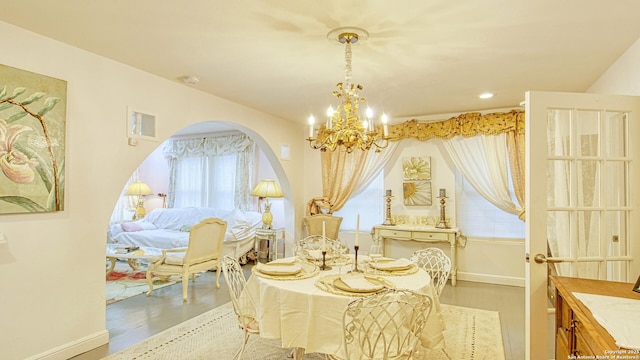 living area with hardwood / wood-style floors and a notable chandelier