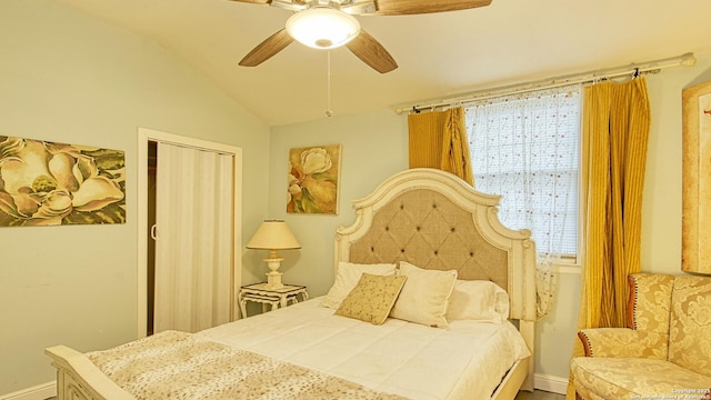 bedroom featuring lofted ceiling, ceiling fan, and a closet