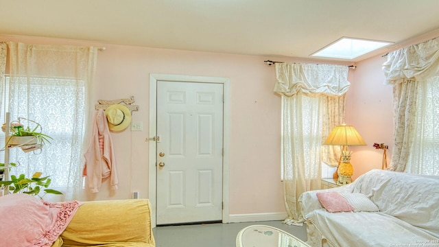 sitting room featuring a skylight and a healthy amount of sunlight