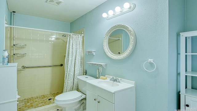 bathroom featuring toilet, vanity, and a shower with curtain