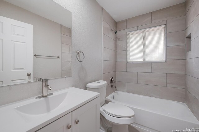 full bathroom with toilet, vanity, and tiled shower / bath