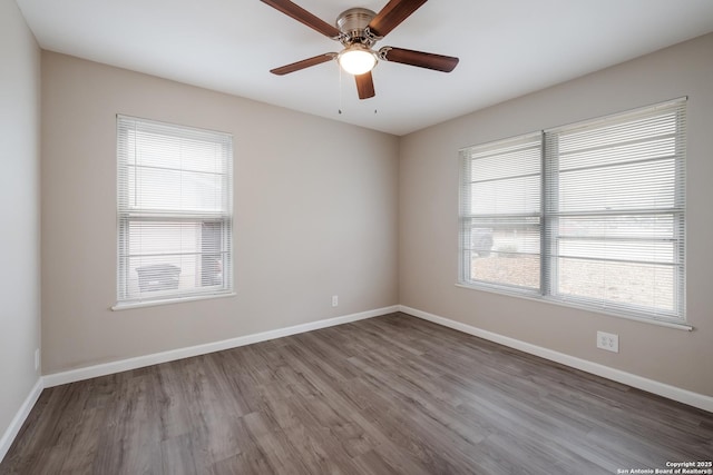 spare room featuring ceiling fan, wood-type flooring, and plenty of natural light