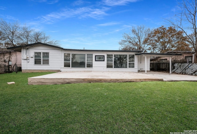 back of house featuring a yard and a patio