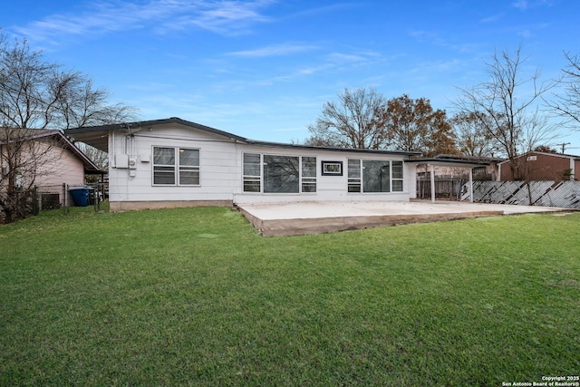 rear view of house with a patio area and a yard