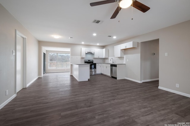 kitchen featuring ceiling fan, appliances with stainless steel finishes, dark wood-type flooring, white cabinets, and sink