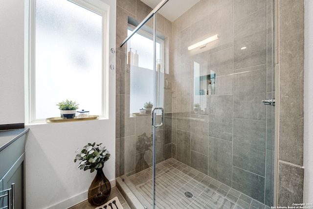 bathroom with a wealth of natural light and an enclosed shower