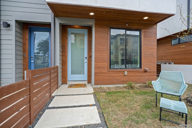 doorway to property featuring a lawn