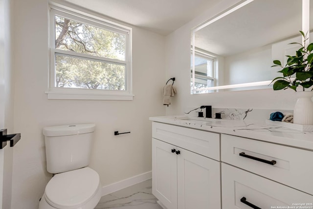 bathroom featuring toilet and vanity