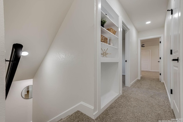 corridor featuring light colored carpet