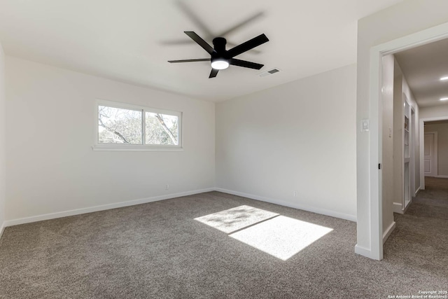 carpeted spare room with ceiling fan