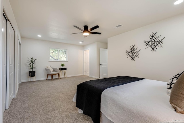 bedroom featuring ceiling fan, a closet, and light carpet