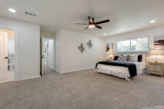 bedroom with connected bathroom, ceiling fan, and light colored carpet