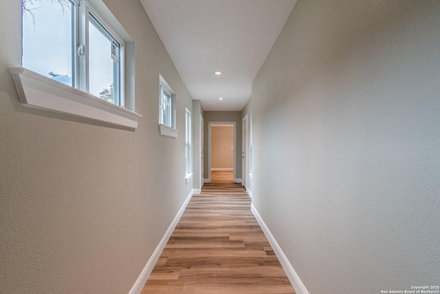 corridor with light wood-type flooring