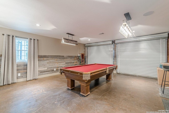 recreation room with billiards, wooden walls, and concrete flooring