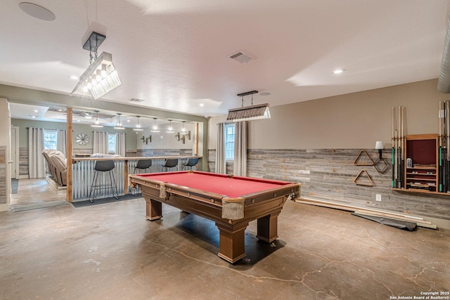 rec room with concrete floors, billiards, indoor bar, and wooden walls