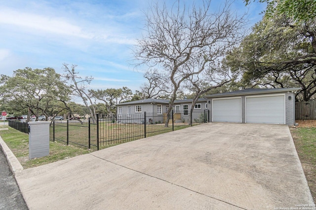 view of front of property with a front lawn, a garage, and an outdoor structure