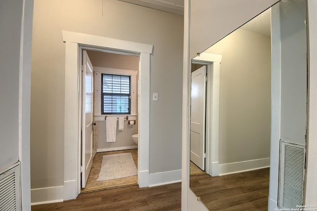 bathroom with visible vents, baseboards, and wood finished floors