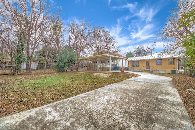 view of front of house with a front yard, driveway, and fence