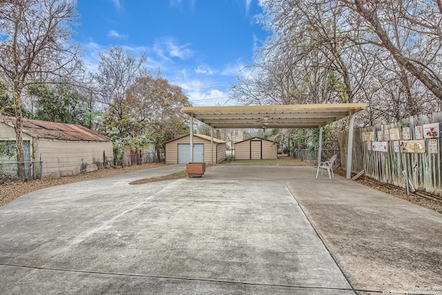 view of car parking featuring a shed and fence