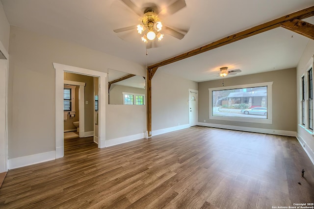 spare room featuring plenty of natural light, wood finished floors, and a ceiling fan