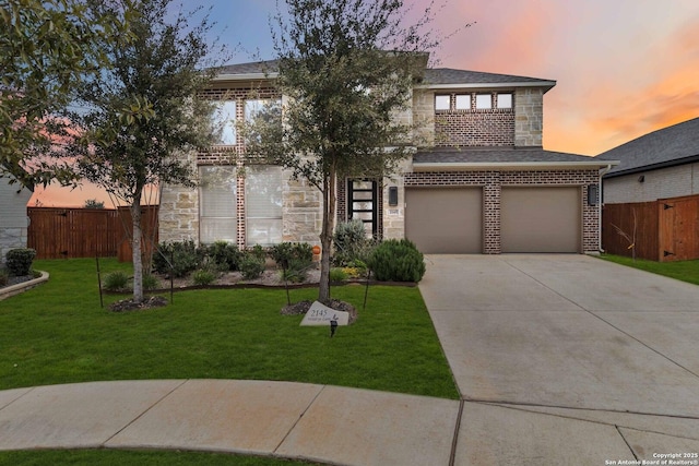 view of front of home with a garage and a yard