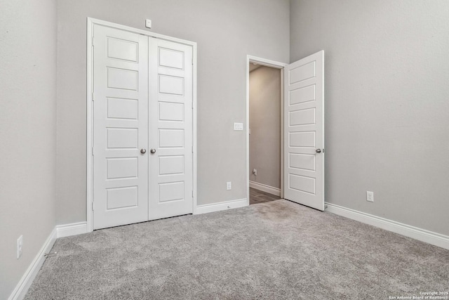 unfurnished bedroom with a closet and carpet flooring