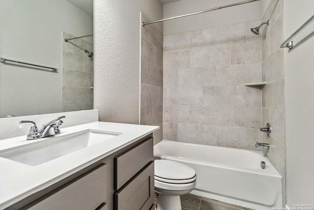 full bathroom with toilet, vanity, and tiled shower / bath