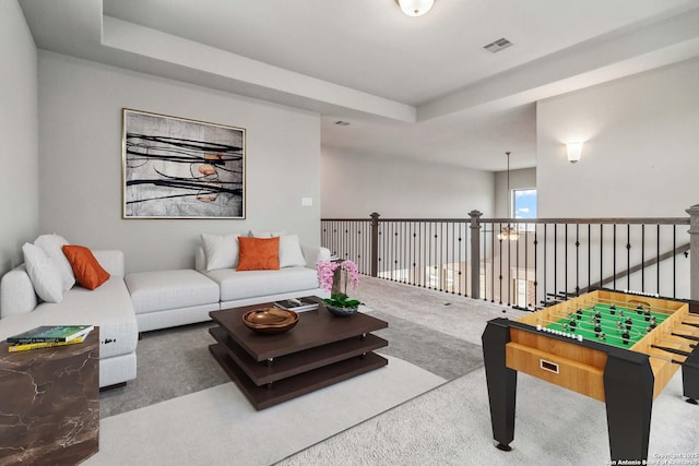 interior space featuring a raised ceiling and carpet floors