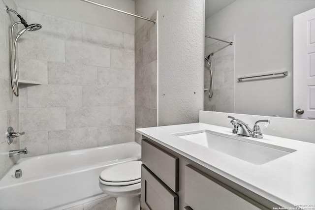 full bathroom featuring toilet, tiled shower / bath, and vanity