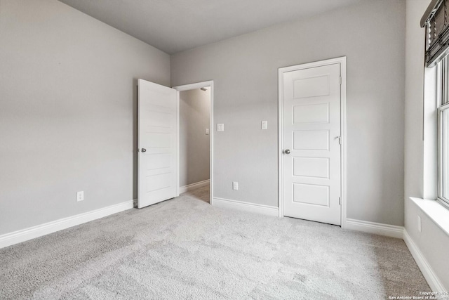 unfurnished bedroom with light colored carpet