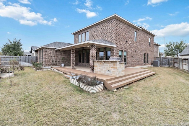 rear view of property featuring a wooden deck, central AC unit, and a lawn