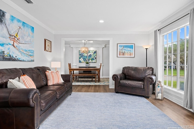 living room featuring hardwood / wood-style floors and ornamental molding