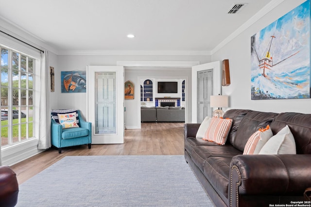 living room featuring ornamental molding and light hardwood / wood-style floors