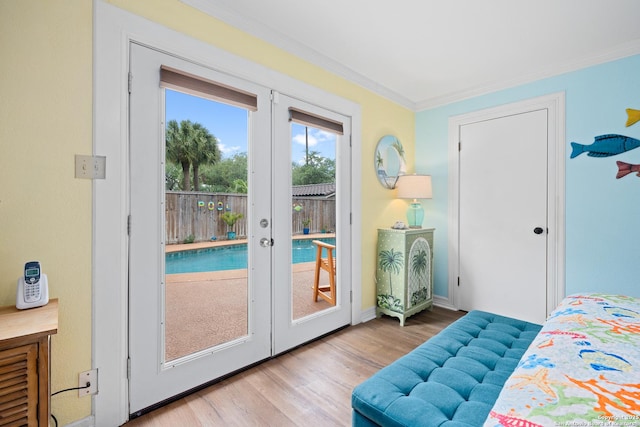 doorway with french doors, crown molding, and light hardwood / wood-style flooring