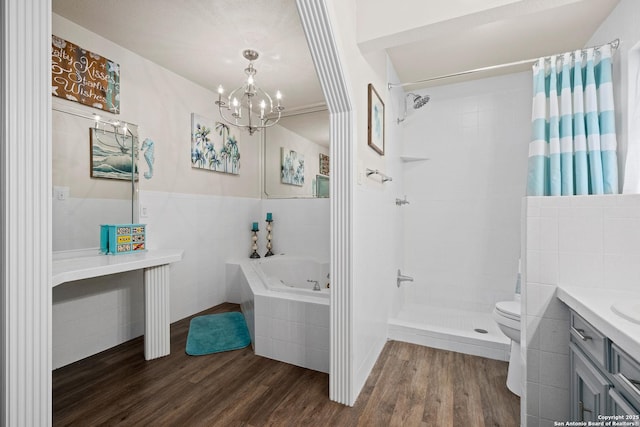 full bathroom with separate shower and tub, vanity, toilet, hardwood / wood-style flooring, and a chandelier