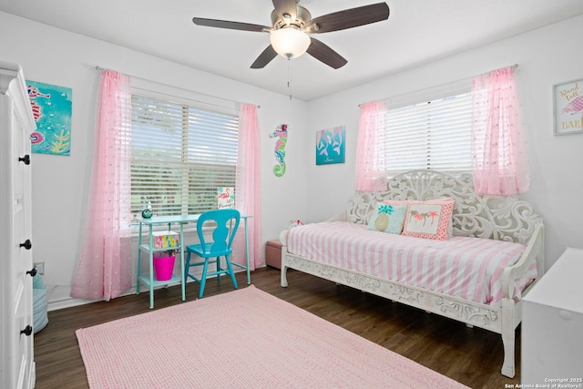 bedroom with ceiling fan and dark hardwood / wood-style floors