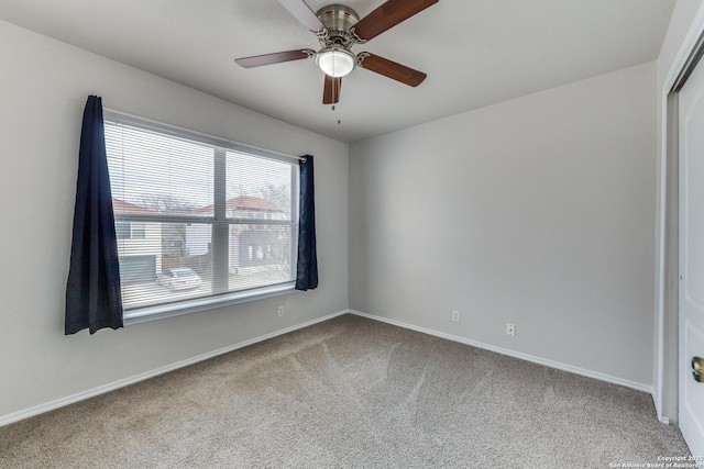 unfurnished room featuring ceiling fan and carpet flooring