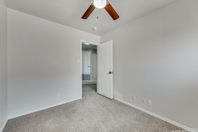 unfurnished room with ceiling fan and light carpet