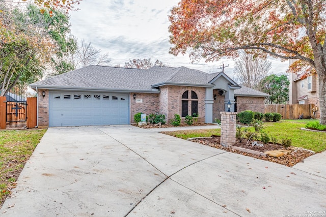 ranch-style home featuring a garage and a front lawn