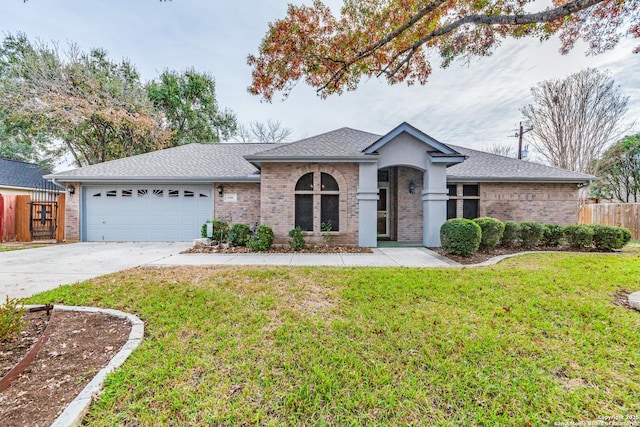 single story home with a garage and a front lawn