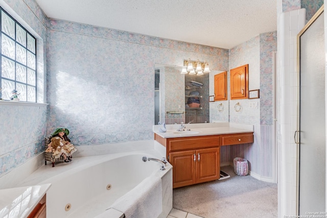 bathroom with a textured ceiling, tile patterned flooring, shower with separate bathtub, and vanity