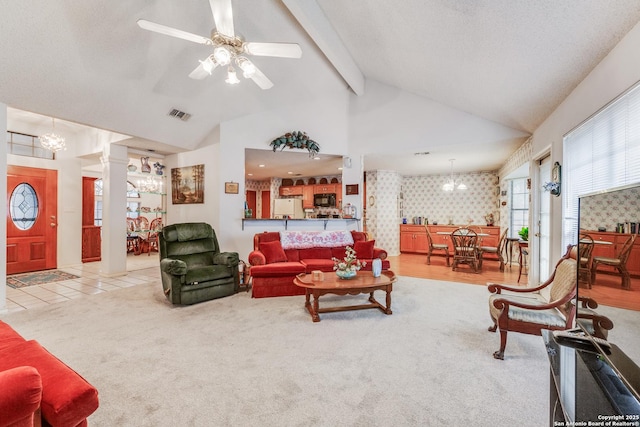 carpeted living room featuring ceiling fan, vaulted ceiling with beams, and decorative columns