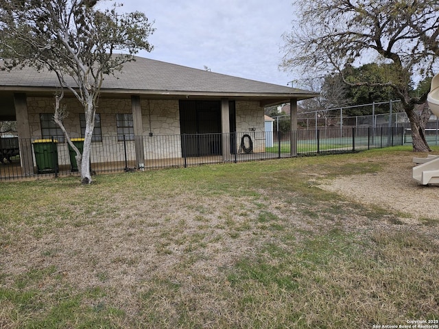 rear view of property with a lawn