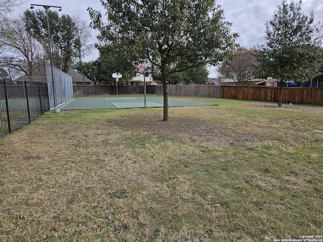 view of yard with basketball hoop