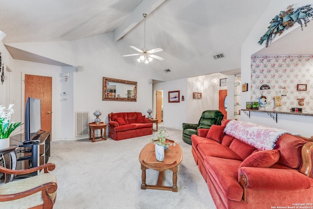 carpeted living room featuring ceiling fan and lofted ceiling with beams