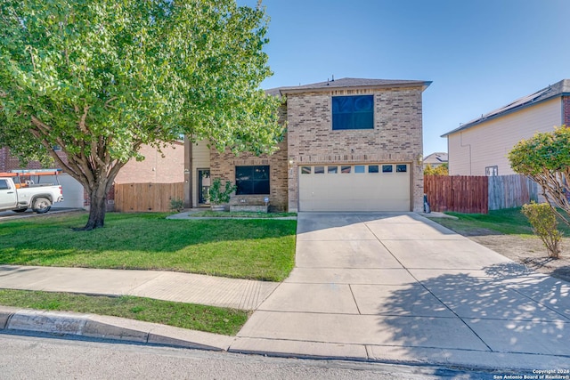 view of property featuring a front yard and a garage