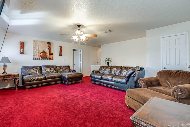 carpeted living room featuring a textured ceiling and ceiling fan