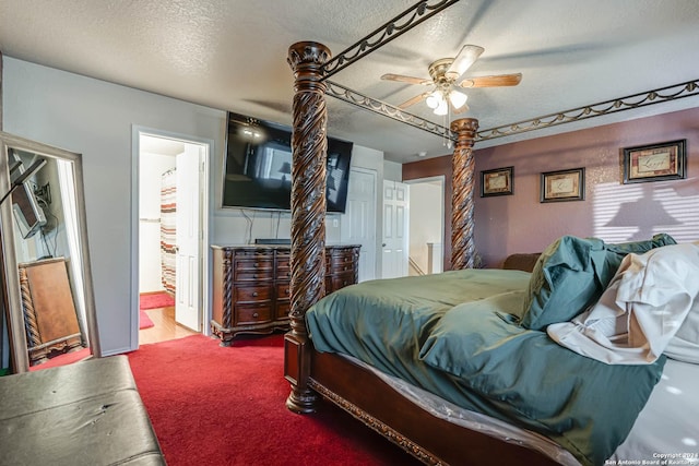 carpeted bedroom featuring ceiling fan, a textured ceiling, and ensuite bathroom